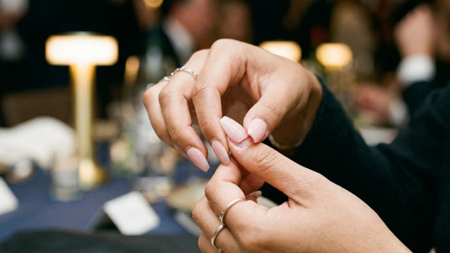 Lifted acrylic nail at a wedding event showing why timing your nail appointment matters

